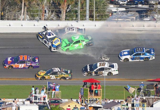 NASCAR driver Chase Elliott (9), Kasey Kahne (95) and Danica Patrick (7) crash during the Daytona 500 at Daytona International Speedway at Daytona Beach in Florida on Sunday