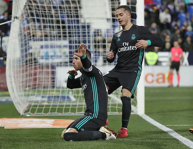 Real Madrid’s Sergio Ramos celebrates with teammate Lucas Vazquez after scoring their third goal from the penalty spot against Leganes during their La Liga match at Butarque Municipal Stadium, in Leganes on Wednesday