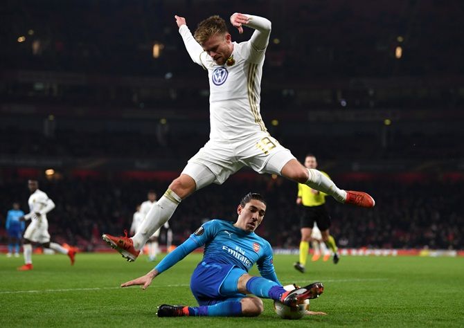 Ostersunds FK's Dennis Widgren evades a challenge by Arsenal's Hector Bellerin during their UEFA Europa League Round of 32 match at the Emirates Stadium in London on Thursday