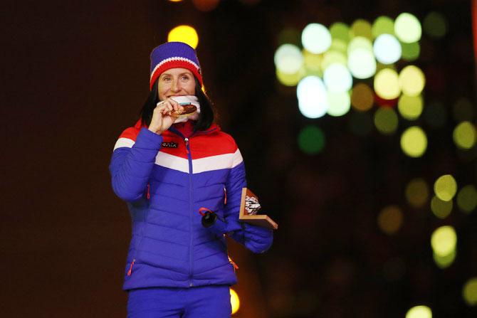 Norway's gold medalist Marit Bjorgen poses during the medal ceremony for the Cross-Country Skiing - Ladies' 30km Mass Start Classic during the Closing Ceremony of the PyeongChang 2018 Winter Olympic Games at PyeongChang Olympic Stadium in Pyeongchang, South Korea, on Sunday