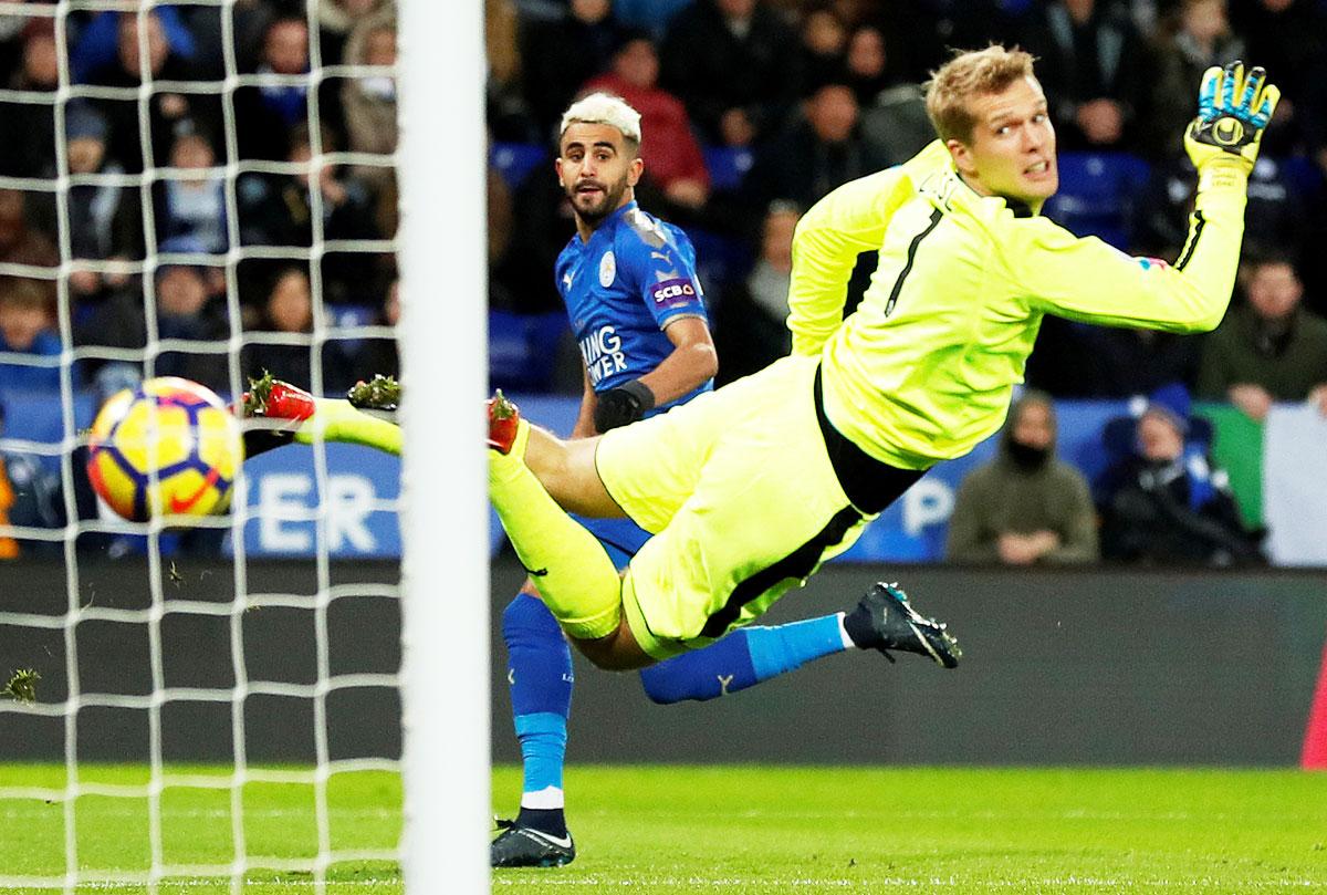 Leicester City's Riyad Mahrez scores their first goal against Huddersfield Town during their English Premier League match at King Power Stadium in Leicester on Monday