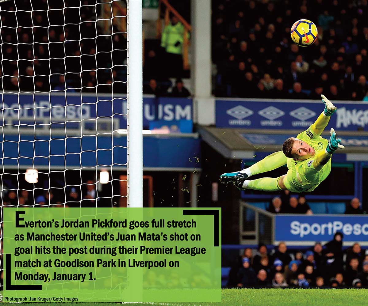 Everton’s Jordan Pickford goes full stretch as Manchester United’s Juan Mata’s shot on goal hits the post during their Premier League match at Goodison Park in Liverpool on Monday, January 1