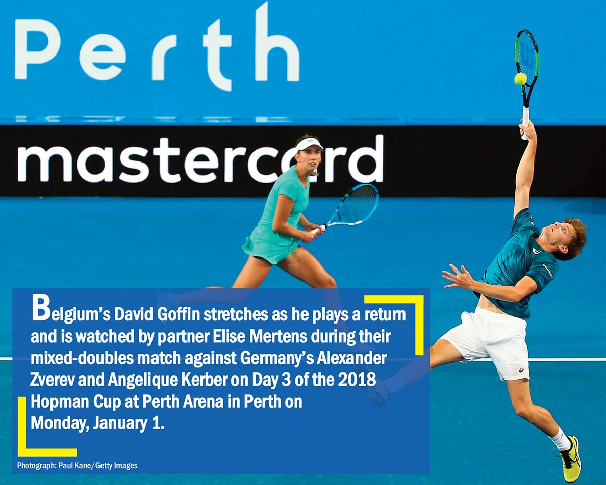 Belgium’s David Goffin stretches as he plays a return and is watched by partner Elise Mertens during their mixed-doubles match against Germany’s Alexander Zverev and Angelique Kerber on Day 3 of the 2018 Hopman Cup at Perth Arena in Perth on Monday January 1