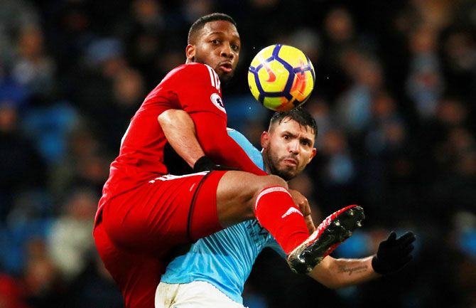 Manchester City's Sergio Aguero and Watford's Molla Wague vie for possession