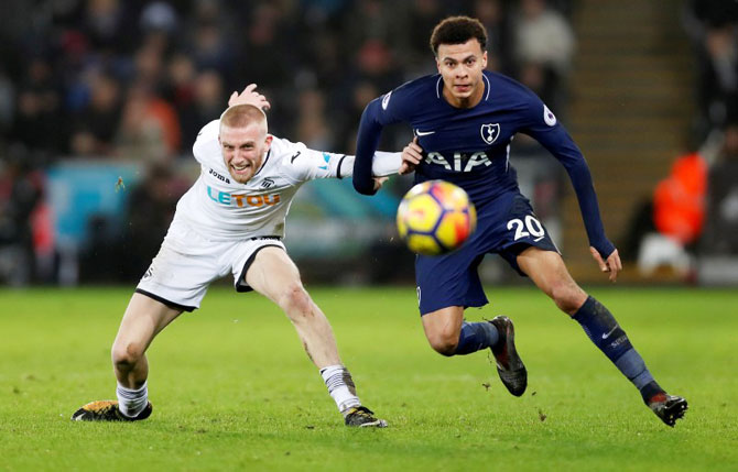 Swansea City's Oliver McBurnie in action with Tottenham's Dele Alli