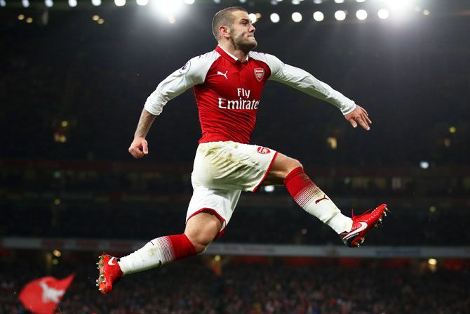 Arsenal's Jack Wilshere celebrates after scoring his side's first goal during their English Premier League at the Emirates Stadium in London