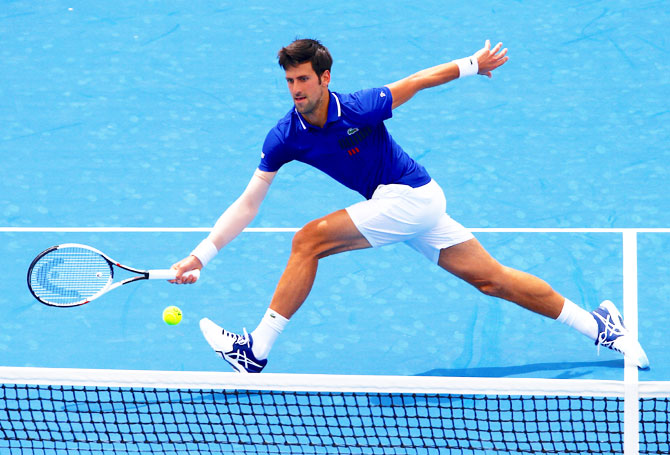 Serbia's Novak Djokovic stretches to play a forehand return during his match against Austria's Dominic Thiem at the Kooyong Classic at Kooyong Lawn Tennis Club in Melbourne on Wednesday