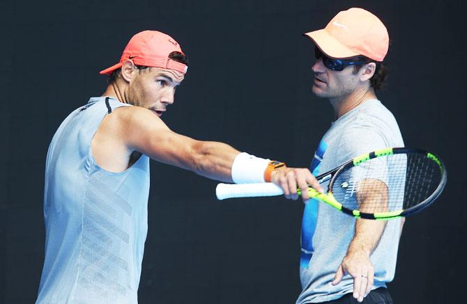 Rafael Nadal in deep discussion with coach Carlos Moya at a training session in Melbourne on Wednesday