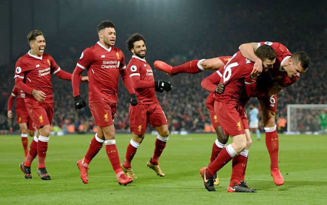 Liverpool players celebrate after Sadio Mane scores the third goal against Mancbester City during their English Premier League match at Anfield in Liverpool on Sunday