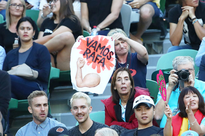 A fan holds up a sign board during the match between Rafael Nadal and Victor Estrella Burgos