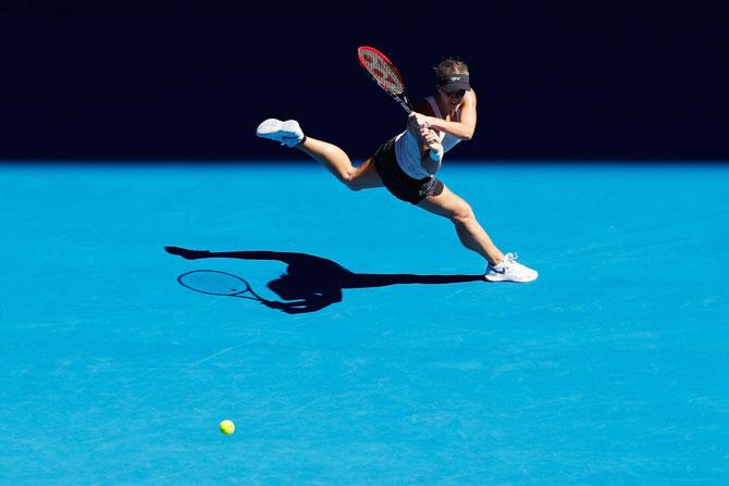 Jana Fett plays a backhand in her second round match against Caroline Wozniacki