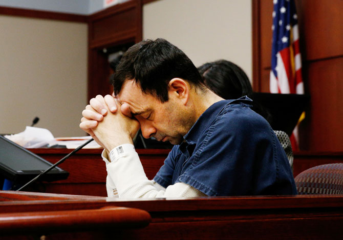 Dr Larry Nassar, a former team USA Gymnastics doctor who pleaded guilty in November 2017 to sexual assault charges, listens to a victim during his sentencing hearing on Tuesday