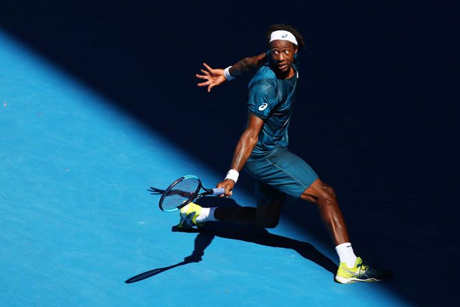 Gael Monfils plays a backhand in his second round match against Novak Djokovic