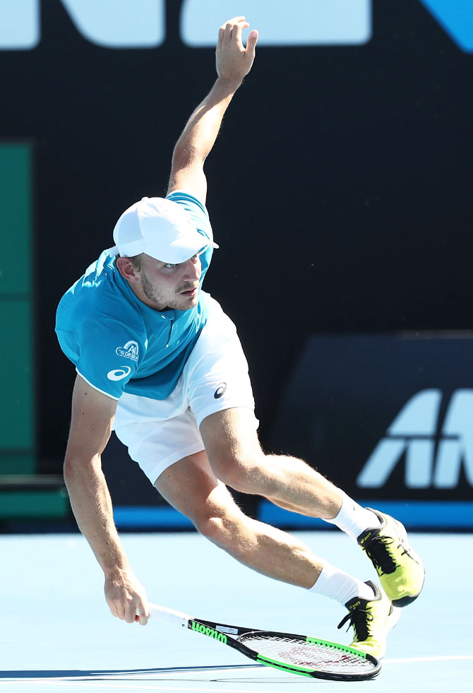 Belgium's David Goffin stumbles in his second round match against France's Julien Benneteau