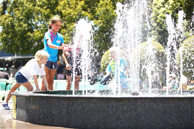 Young fans play in the fountain in Garden Square at Melbourne Park