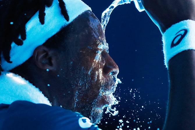 Gael Monfils cools down between games in his second round match against Novak Djokovic