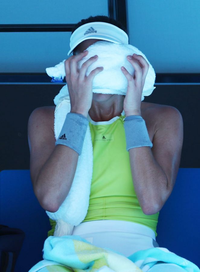 Spain's Garbine Muguruza places an ice-pack to get some respite from the heat during her loss against Taiwanese doubles specialist Hsieh Su-wei