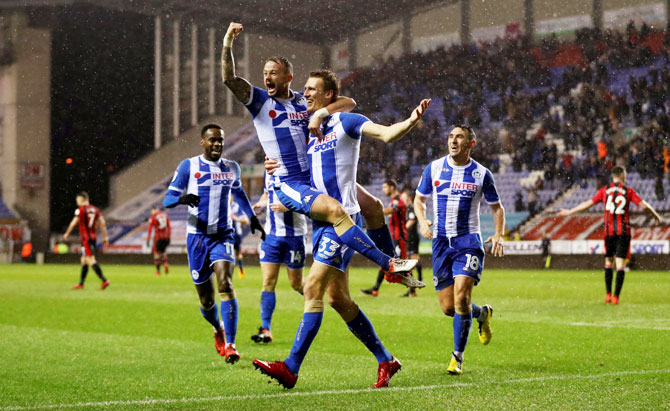 Wigan Athletic’s Dan Burn celebrates scoring their second goal with teammate Noel Hunt during their FA Cup Third Round Replay against Bournemouth at DW Stadium in Wigan on Wednesday