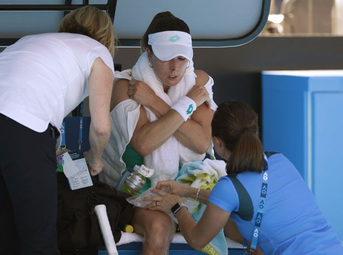 France's Alize Cornet receives medical assistance during her match against Belgium's Elise Mertens on Friday
