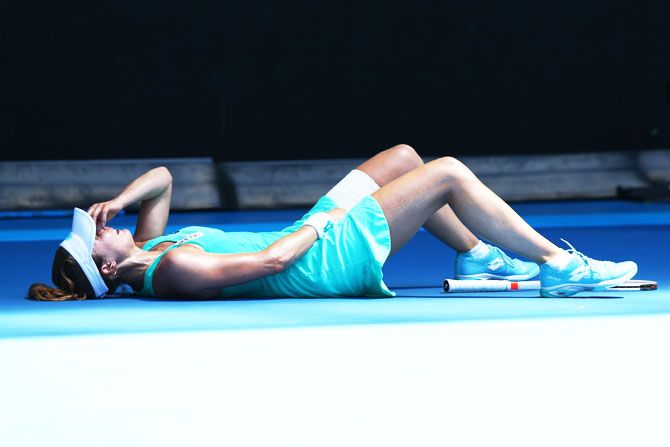 France's Alize Cornet struggles with the heat in her third round match against Belgium's Elise Mertens on day five of the 2018 Australian Open at Melbourne Park on Friday