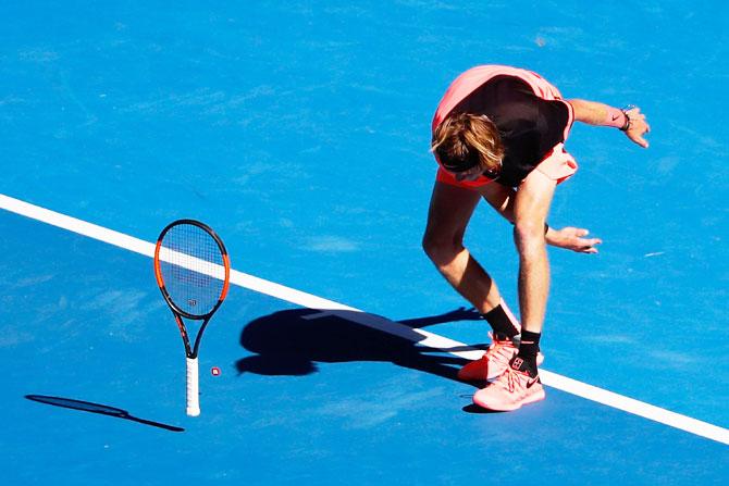 Andrey Rublev throws his racquet in frustration