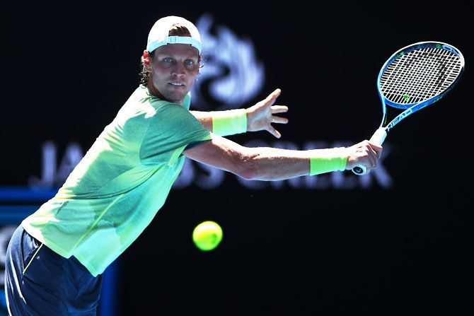 The Czech Republic's Tomas Berdych plays a backhand in his fourth round match against Italy's Fabio Fognini