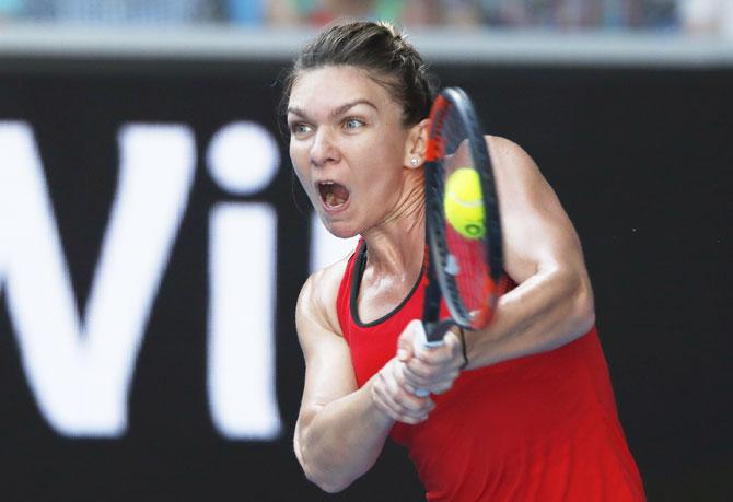 Romania's Simona Halep hits a return against Japan's Naomi Osaka