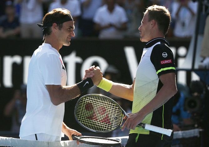 Roger Federer is congratulated by Marton Fucsovics after their match