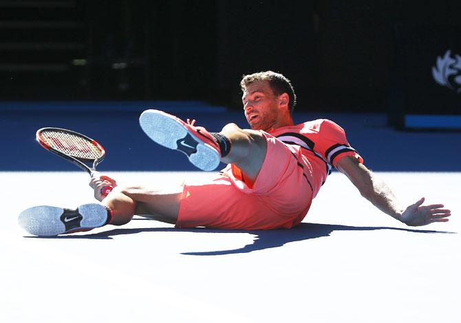 Grigor Dimitrov falls during his match against Kyle Edmund