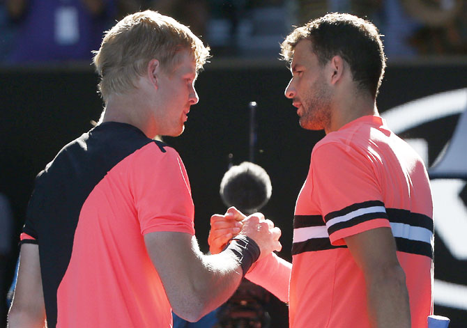 Kyle Edmund is congratulated by Grigor Dimitrov after their match