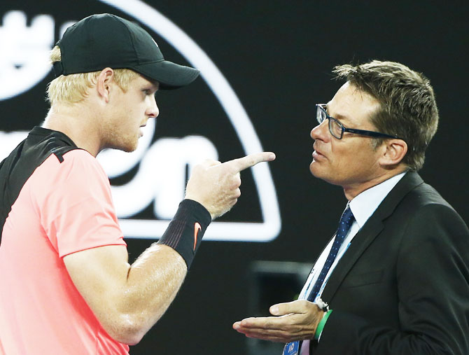 Kyle Edmund speaks with an official after arguing with umpire John Blom