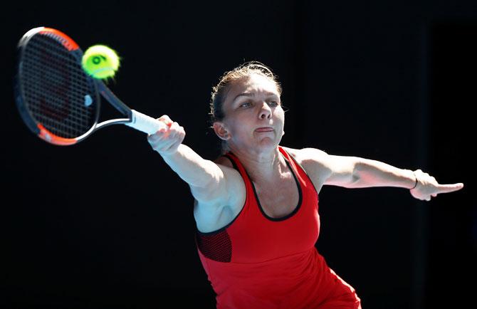 Simona Halep stretches as she plays a forehand return