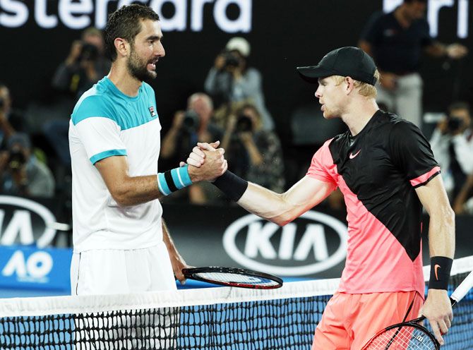 Marin Cilic is congratulated by Kyle Edmund after the match