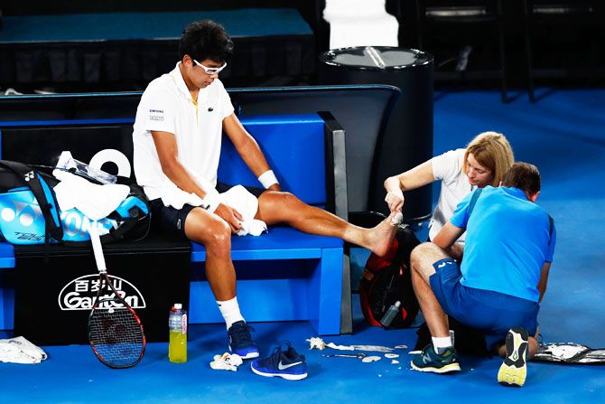 Hyeon Chung receives medical attention for an injured foot in his semi-final against Roger Federer