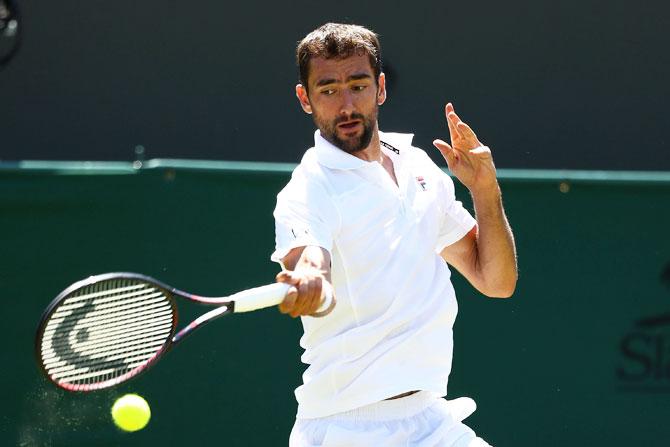 Croatia's Marin Cilic returns against Japan's Yoshihito Nishioka during their men's singles first round match