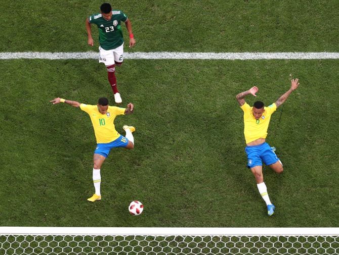 Neymar, left, scores Brazil's first goal