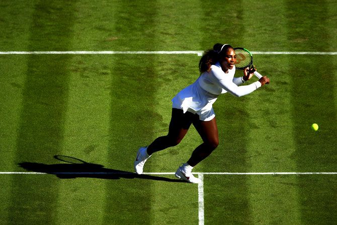 Serena Williams plays a return against Arantxa Rus during her first round match at Wimbledon on Monday