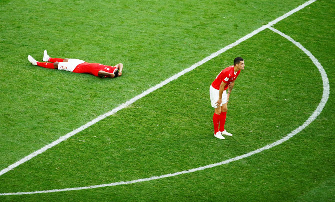 Switzerland's Manuel Akanji and Granit Xhaka look dejected at the end of the match 