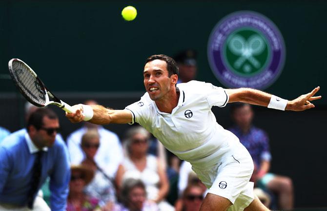 Kazakhstan's Mikhail Kukushkin returns a shot against Spain's Rafael Nadal