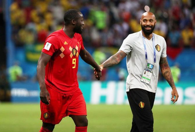 Belgium's Romelu Lukaku celebrates with assistant coach Thierry Henry after their win over Brazil on Friday