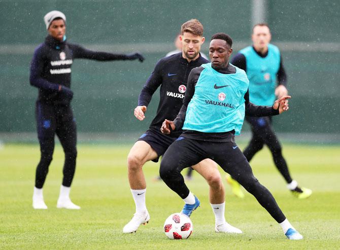 England's Danny Welbeck holds off Gary Cahill during a training session