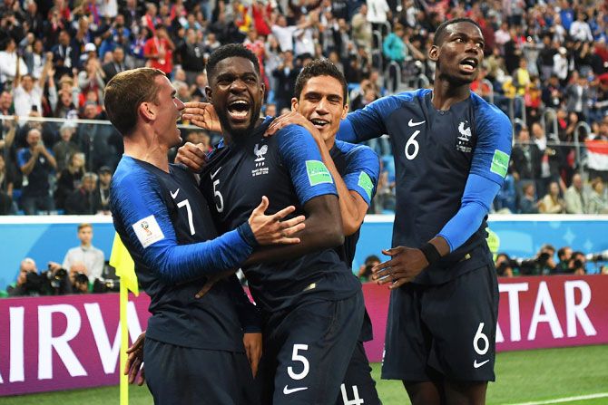 France's Samuel Umtiti celebrates with teammates after heading in the first goal, that eventually proved to be the match-winning goal, during the 2018 FIFA World Cup semi-final against Belgium at Saint Petersburg Stadium in Saint Petersburg, Russia, on Tuesday
