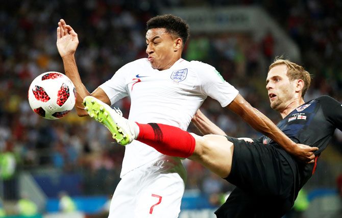 England's Jesse Lingard hold off Croatia's Ivan Strinic as they vie for possession