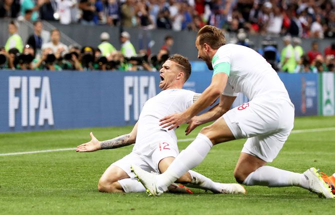 England's Kieran Trippier celebrates with teammate Harry Kane after scoring their opening goal