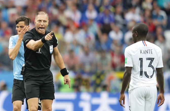 Referee Nestor Pitana talks to Ngolo Kante of France 