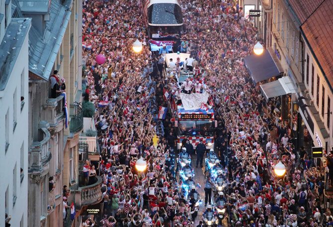 The Croatian football team bus is surrounded by hoards of jubilant supporters during a parade in Zagreb on Tuesday
