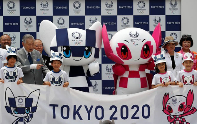Yoshiro Mori, president of the Tokyo 2020 Organising Committee, and Tokyo Governor Yuriko Koike pose for a group photo with Tokyo 2020 Olympic Games mascot Miraitowa and Paralympic mascot Someity during the mascots' debut in Tokyo, Japan, on Sunday