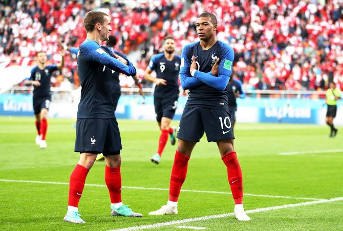 France's Kylian Mbappe celebrates with teammate Antoine Griezmann after scoring his team's first goal against Peru in their Group C match