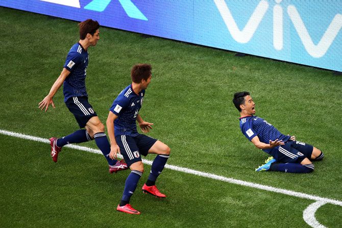 Japan's Shinji Kagawa celebrates with teammates Yuya Osako of Japan and Takashi Inui after scoring his team's first goal from the penalty spot in their Group H match against Colombia