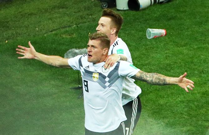 Germany's Toni Kroos celebrates with teammate Marco Reus after scoring their first goal against Sweden in their Group F match